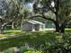 A serene community pool area surrounded by lush greenery and mature trees, offers a tranquil retreat at 11941 Skylake Pl # 11941, Temple Terrace, FL 33617