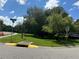 A well-manicured streetscape featuring lush greenery, mature trees, and a street sign at 11941 Skylake Pl # 11941, Temple Terrace, FL 33617