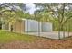 Fenced tennis court with trees providing shade at 11941 Skylake Pl # 11941, Temple Terrace, FL 33617