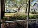 Screened-in patio with a view of lush landscaping, mature trees, and a parking area at 11941 Skylake Pl # 11941, Temple Terrace, FL 33617