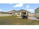 Large fenced backyard featuring a patio, lawn area, and parked ATV at 12017 Gillingham Harbor Ln, Gibsonton, FL 33534