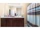 Well-lit bathroom featuring double sinks and a shower with stylish curtain at 12017 Gillingham Harbor Ln, Gibsonton, FL 33534