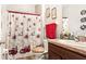 Neat bathroom with a festive holiday shower curtain, coordinated towels, and a clean, functional space at 12017 Gillingham Harbor Ln, Gibsonton, FL 33534