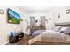 Tastefully decorated bedroom featuring wood floors, crown molding, and a modern TV at 12017 Gillingham Harbor Ln, Gibsonton, FL 33534