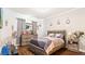 Comfortable bedroom with wood floors and a full-sized bed, dresser, and tasteful decor at 12017 Gillingham Harbor Ln, Gibsonton, FL 33534
