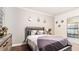 Comfortable bedroom with wood floors and a full-sized bed, dresser, and attached bathroom at 12017 Gillingham Harbor Ln, Gibsonton, FL 33534