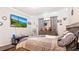 Tastefully decorated bedroom featuring wood floors, crown molding, and a modern TV at 12017 Gillingham Harbor Ln, Gibsonton, FL 33534
