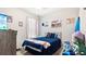Inviting bedroom with baseball-themed decor, a comfortable bed, and ample natural light at 12017 Gillingham Harbor Ln, Gibsonton, FL 33534