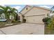 Charming home featuring a well-manicured lawn and two-car garage with a stylish design at 12017 Gillingham Harbor Ln, Gibsonton, FL 33534