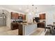 Kitchen with tile floors, dark wood cabinets, granite countertops, and a matching tile accent on the island at 12017 Gillingham Harbor Ln, Gibsonton, FL 33534