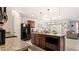 A kitchen features wood cabinets, granite countertops, an island, and stainless steel appliances at 12017 Gillingham Harbor Ln, Gibsonton, FL 33534