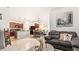 Living room features a gray couch, a coffee table, and an open concept kitchen and dining area at 12017 Gillingham Harbor Ln, Gibsonton, FL 33534