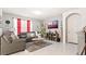 Comfortable living room featuring a leather sofa, soft rug, and a television with a white paint color at 12017 Gillingham Harbor Ln, Gibsonton, FL 33534