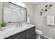 Modern bathroom featuring a white vanity top, black framed mirror, and subway tiled shower at 1320 Oak Valley Dr, Seffner, FL 33584