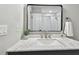 Bright bathroom with a white vanity top, modern faucet, and a view of the tiled shower at 1320 Oak Valley Dr, Seffner, FL 33584