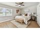 Bright bedroom showcasing a large window, ceiling fan, and neutral decor at 1320 Oak Valley Dr, Seffner, FL 33584