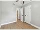 Empty bedroom with open doors featuring new flooring and neutral paint at 1320 Oak Valley Dr, Seffner, FL 33584