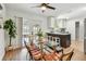 Open-concept dining area with modern table and view of the stylish kitchen at 1320 Oak Valley Dr, Seffner, FL 33584