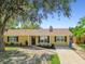 Inviting single-story home featuring a well-maintained lawn and classic design elements at 1320 Oak Valley Dr, Seffner, FL 33584