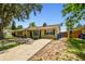 Inviting single-Gathering home with a yellow exterior, black shutters, and well-maintained lawn at 1320 Oak Valley Dr, Seffner, FL 33584