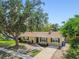 Traditional home with a mature tree in the front yard and well manicured landscaping at 1320 Oak Valley Dr, Seffner, FL 33584