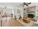 Cozy living room with a fireplace, modern furnishings, and a view into the dining area at 1320 Oak Valley Dr, Seffner, FL 33584