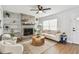 Bright living room featuring a brick fireplace, built-in shelving, a white sofa, and a stylish coffee table at 1320 Oak Valley Dr, Seffner, FL 33584