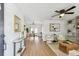 Open-concept living room featuring wood floors, a dining area, modern decor, and abundant natural light at 1320 Oak Valley Dr, Seffner, FL 33584