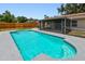 Backyard swimming pool surrounded by a patio area and screen enclosure at 1320 Oak Valley Dr, Seffner, FL 33584