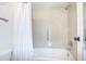Clean bathroom featuring a shower-tub combo with white tile and a shower curtain at 14130 Rosemary Ln # 4215, Largo, FL 33774