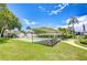Community lawn bowling area with shaded seating, surrounded by beautiful tropical landscaping at 14130 Rosemary Ln # 4215, Largo, FL 33774