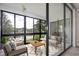 Bright living room features floor-to-ceiling windows with great view, modern furniture, and neutral colors at 14130 Rosemary Ln # 4215, Largo, FL 33774