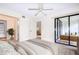 Spacious main bedroom with a slider door to a sunroom provides ample sunlight at 14130 Rosemary Ln # 4215, Largo, FL 33774