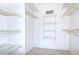 Bright walk-in closet with wall-mounted shelving for storage at 14130 Rosemary Ln # 4215, Largo, FL 33774