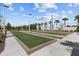 Outdoor bocce ball courts with well maintained landscaping on a sunny day with clear skies at 17418 Holly Well Ave, Wimauma, FL 33598