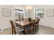 Charming dining room with a rustic wood table and ample natural light at 17418 Holly Well Ave, Wimauma, FL 33598