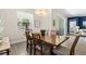 Bright dining room features a wood table with seating for six and sliding glass door at 17418 Holly Well Ave, Wimauma, FL 33598
