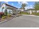 Community entrance with a golf cart parked under a covered entryway surrounded by greenery at 17418 Holly Well Ave, Wimauma, FL 33598