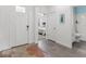Inviting entryway with decorative rug, views into the bedroom, and a bathroom on the right at 17418 Holly Well Ave, Wimauma, FL 33598