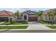Charming single-story home with a tile roof, well-manicured lawn, and a two-car garage at 17418 Holly Well Ave, Wimauma, FL 33598