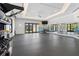 Well-equipped gym featuring free weights, mirrors, and ample natural light at 17418 Holly Well Ave, Wimauma, FL 33598