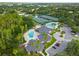 Aerial view of community featuring tennis courts, clubhouse, lush landscaping, pool, and ample parking, offering resort style living at 18004 Avalon Ln, Tampa, FL 33647