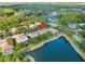 An aerial view of a neighborhood featuring homes surrounding a large pond, showing community amenities at 18004 Avalon Ln, Tampa, FL 33647