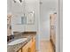 Well-lit bathroom with a granite countertop, vanity, step-in shower and tiled floors at 18004 Avalon Ln, Tampa, FL 33647