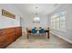 Formal dining room with a traditional chandelier, wood floors, and a large window with plantation shutters at 18004 Avalon Ln, Tampa, FL 33647