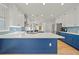Spacious kitchen with white cabinets, blue island, quartz counters, and stainless steel appliances at 18004 Avalon Ln, Tampa, FL 33647
