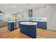Eat-in kitchen with blue cabinets, stainless steel appliances, and access to the outdoor patio at 18004 Avalon Ln, Tampa, FL 33647