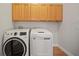 Functional laundry room with washer, dryer, and ample storage space at 18004 Avalon Ln, Tampa, FL 33647