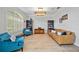 Bright living room with a large window, plantation shutters, wood floors, and comfortable seating at 18004 Avalon Ln, Tampa, FL 33647