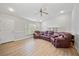 Spacious living room with hardwood floors, vaulted ceiling, and a large sectional sofa at 18004 Avalon Ln, Tampa, FL 33647